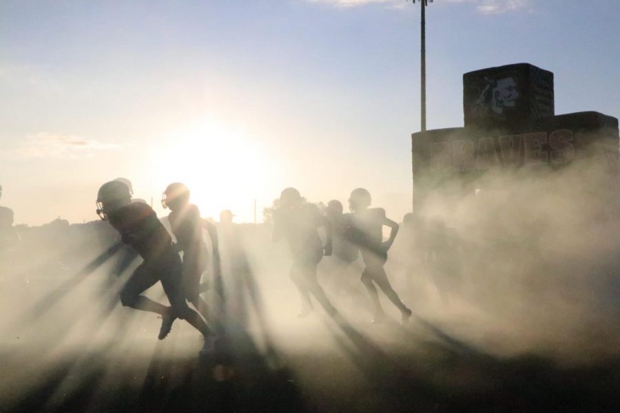In+the+midst+of+the+fog%2C+the+braves+charge+onto+the+field+in+the+home+opener+on+Sept.+13.
