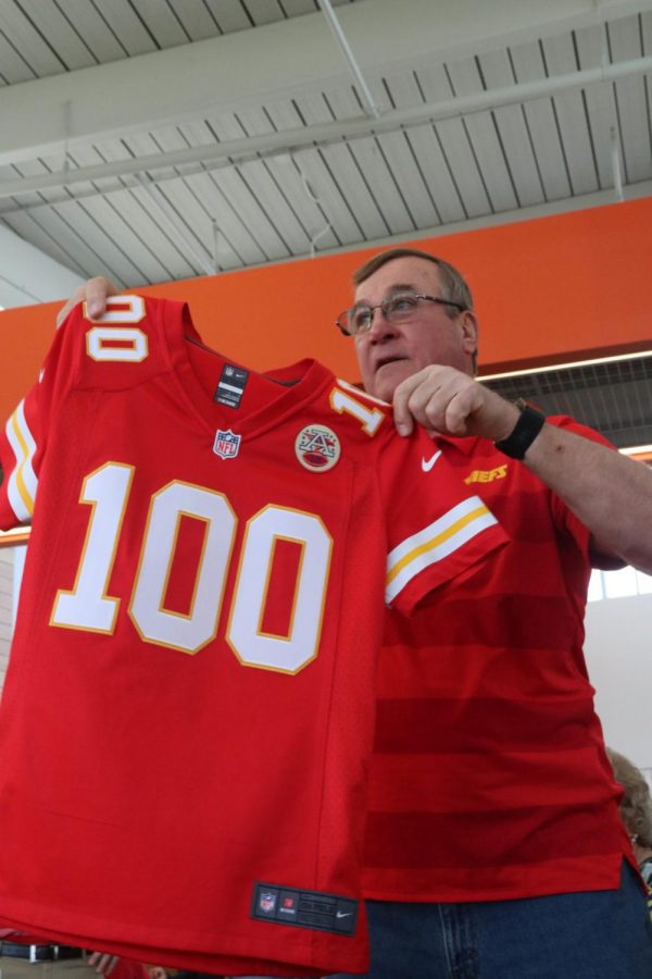 Melbas son, Monte Mitchell, displays his moms custom-made jersey the Chiefs made for her.