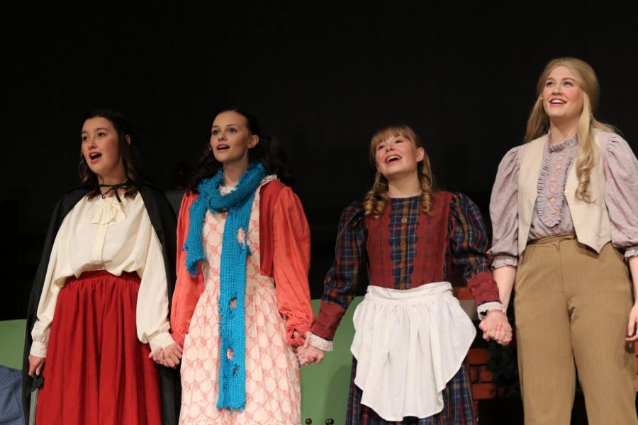 The four March sisters Meg (played by Mackenzie Russell), Amy (played by Lorena Tomasic),  Beth (played by Emma VanBrocklin),  and Jo (played by Emma Prentice).