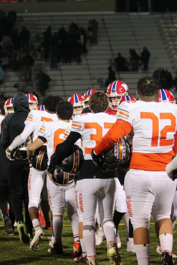 The Braves shake hands with Miege after the final game of the season.