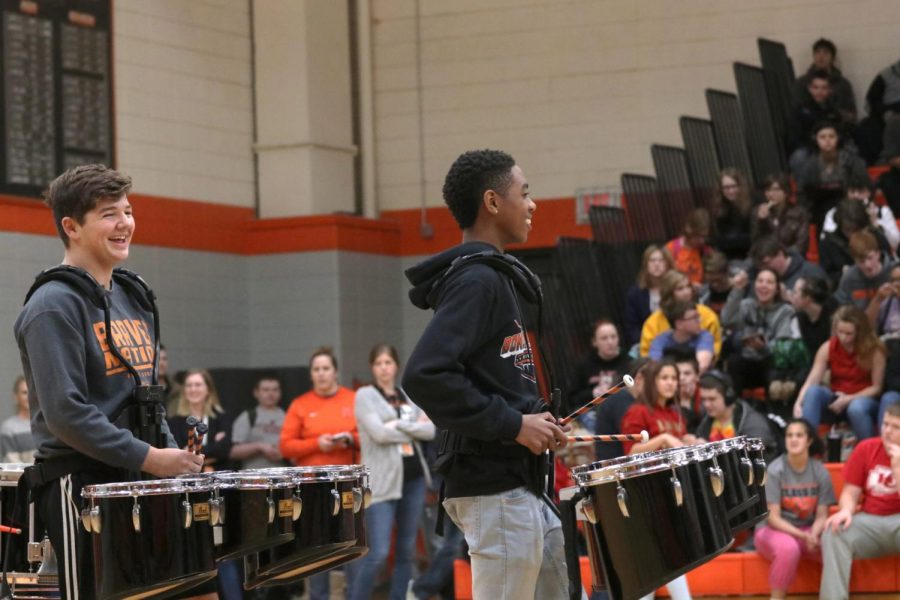 Leading the drumline, junior Christian Doss marches onto the gym floor. 