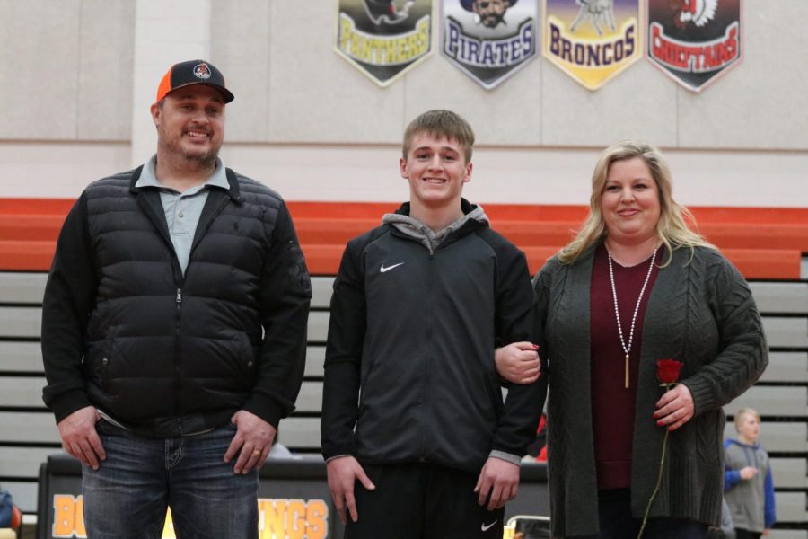 Senior Gage Maxwell and his parents, Brad and Kelly, enjoy senior night festivities on Jan. 30.