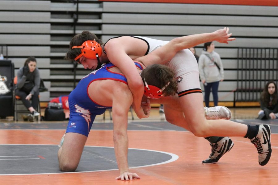 Senior Jackson McArthur locks up a cradle in the senior night duel against Santa Fe Trail. McArthur won the match decisively. 