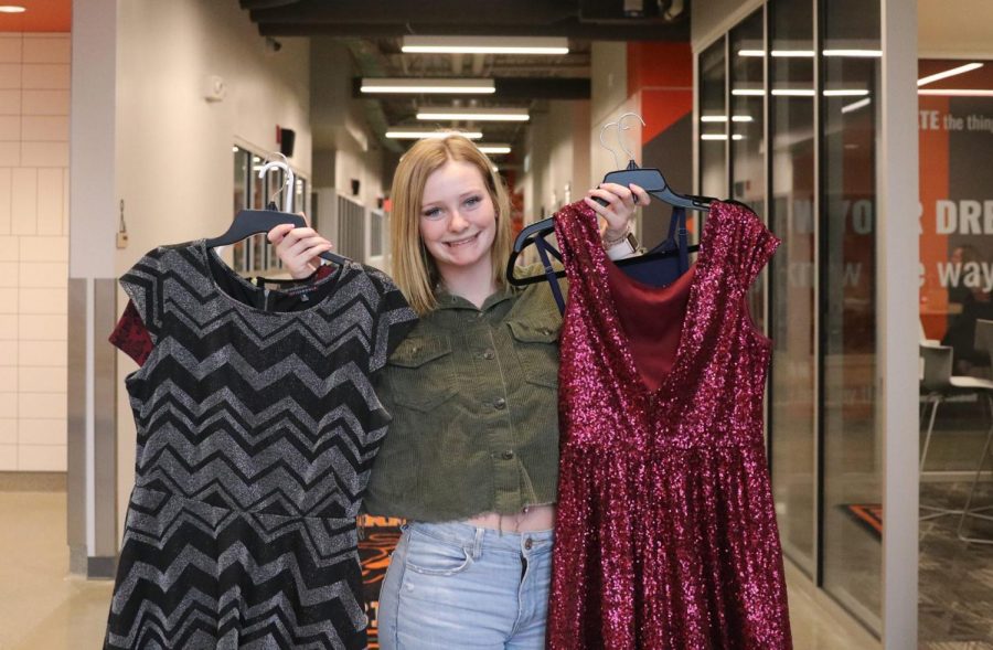 Junior Paige Swartz shows off some of the dresses she’s collected as part of her senior project.