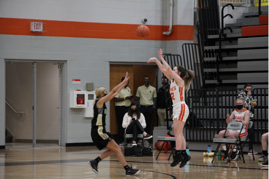 Junior Corrie Hasset takes a shot at the three-point line. 