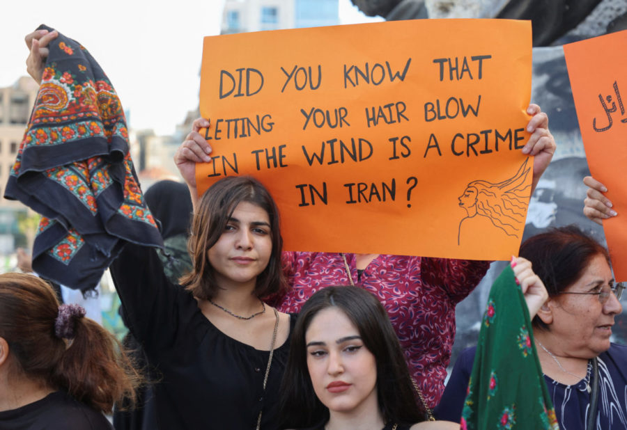 Women take part in a sit-in following the death Aminis passing