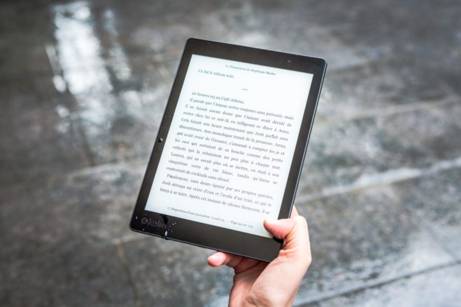 A hand holding an e-reader