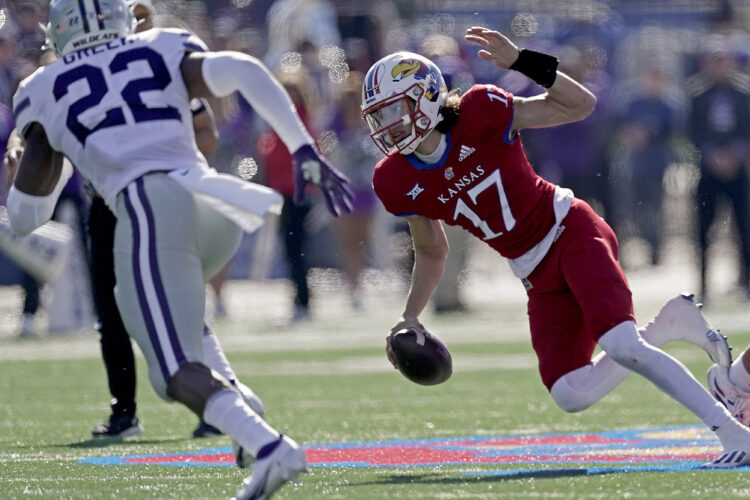 Kansas quarterback Jason Bean (17) gets past Kansas State linebacker Daniel Green (22) during the first half of an NCAA football basketball game against Kansas Saturday, Nov. 6, 2021, in Lawrence, Kan. (AP Photo/Charlie Riedel)