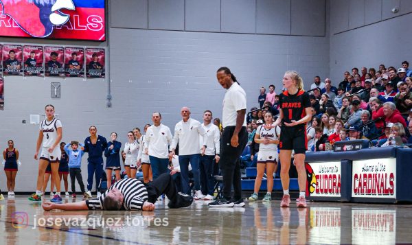 Athletes, coaches, and spectators express concern and confusion after official Jeff Freeman falls to the ground.